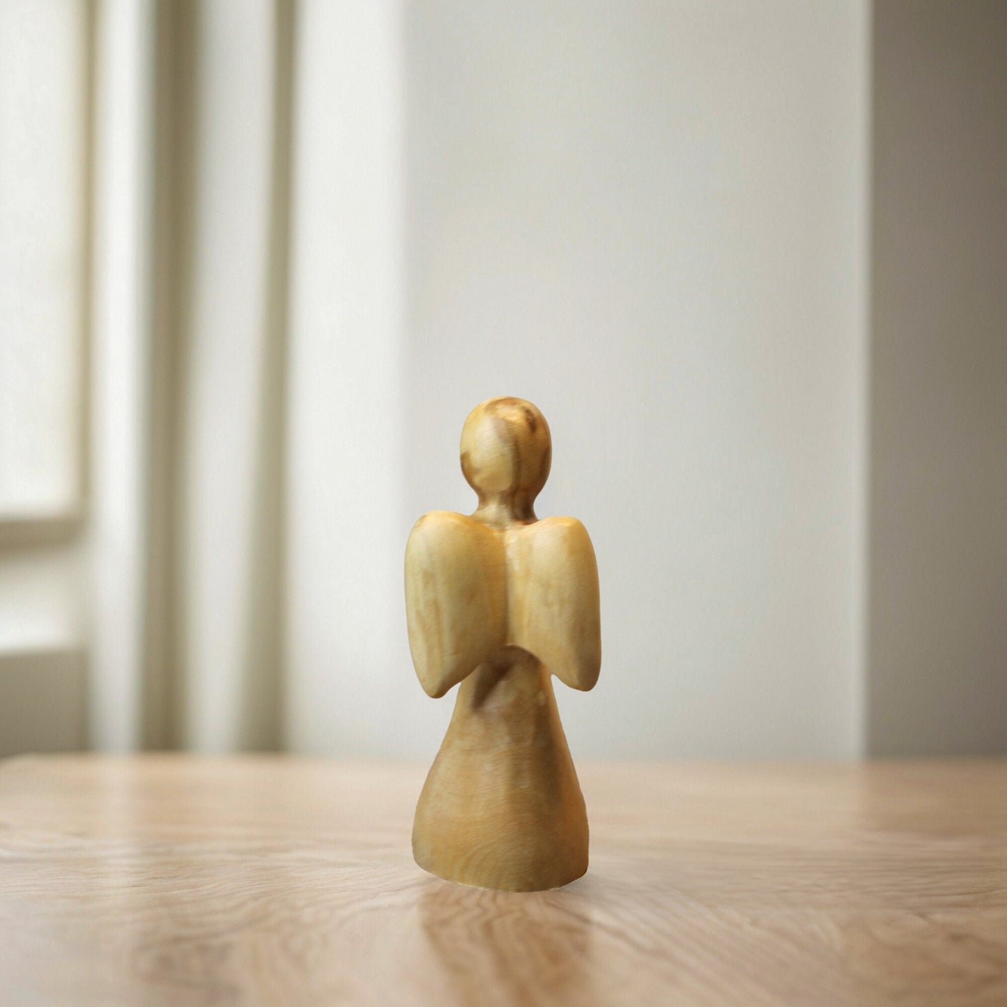 a wooden figurine of an angel on a table