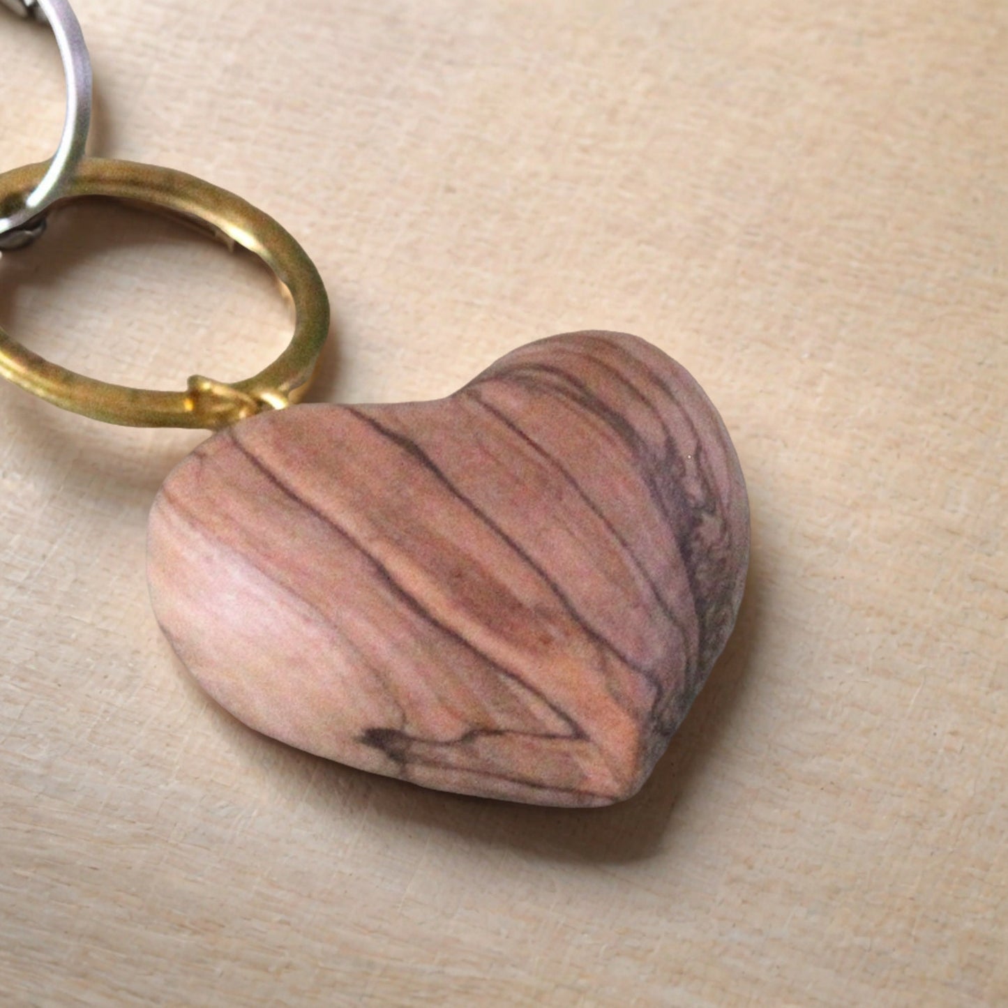 a wooden heart shaped keychain sitting on top of a table
