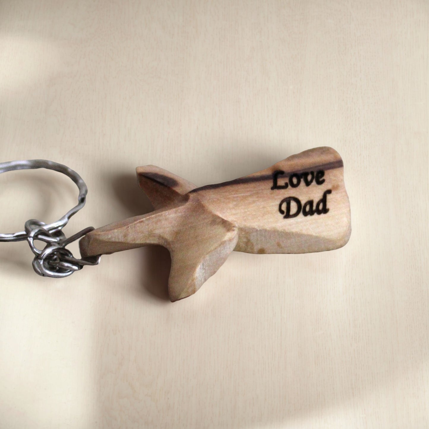 a wooden keychain with the words love dad written on it