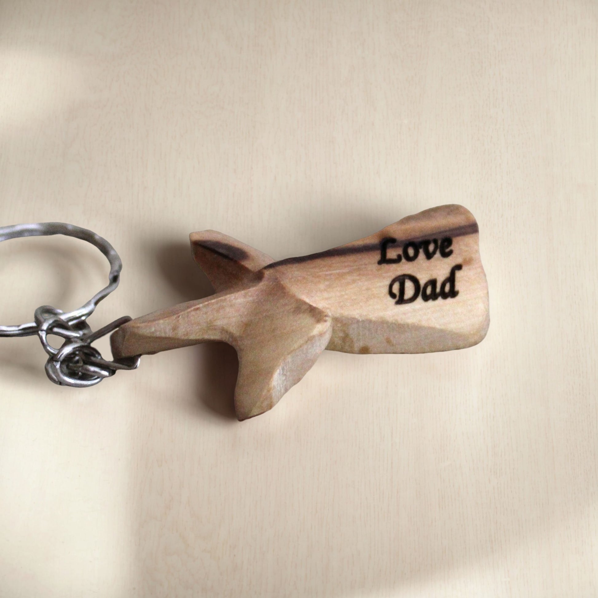 a wooden keychain with the words love dad written on it