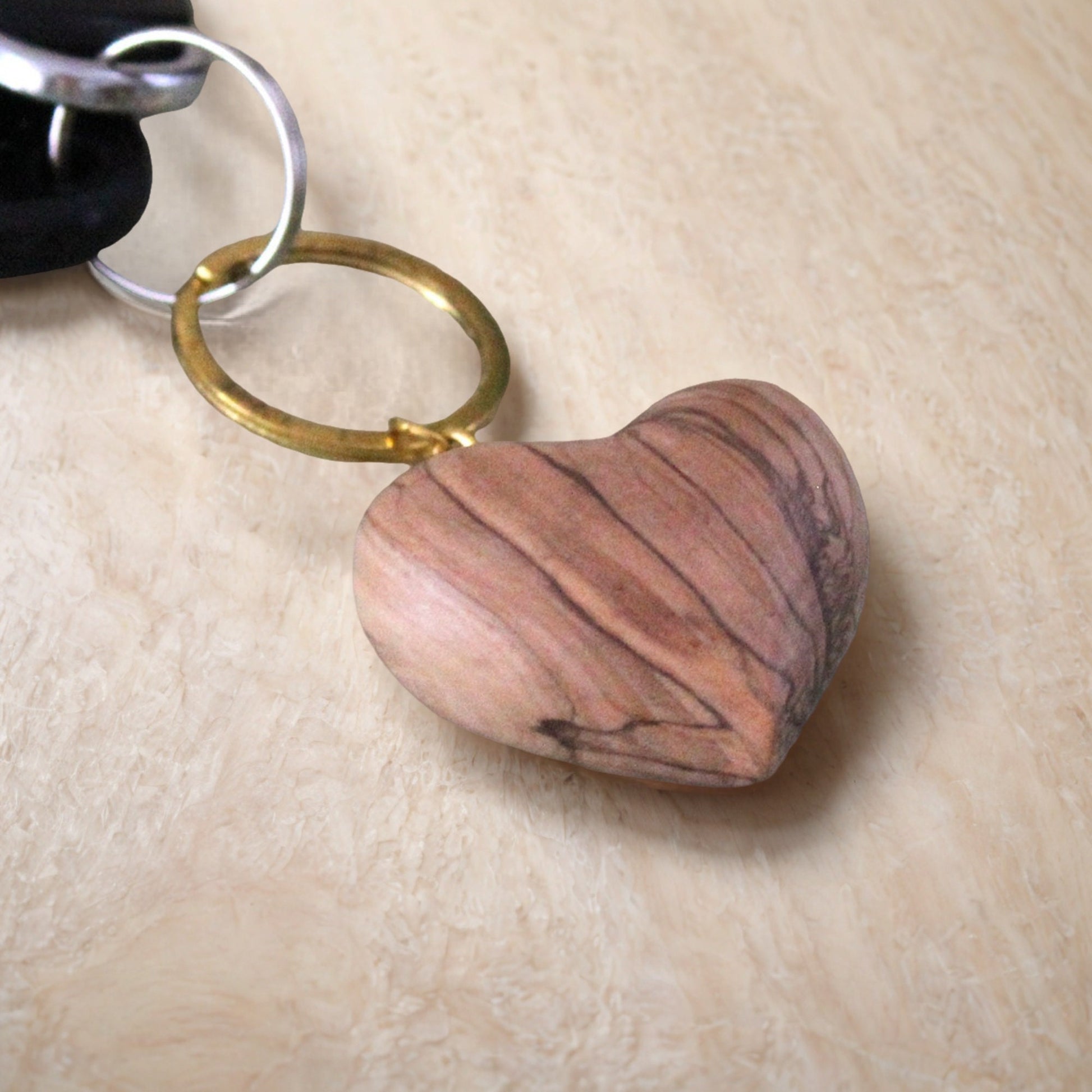 a heart shaped rock sitting on top of a wooden table